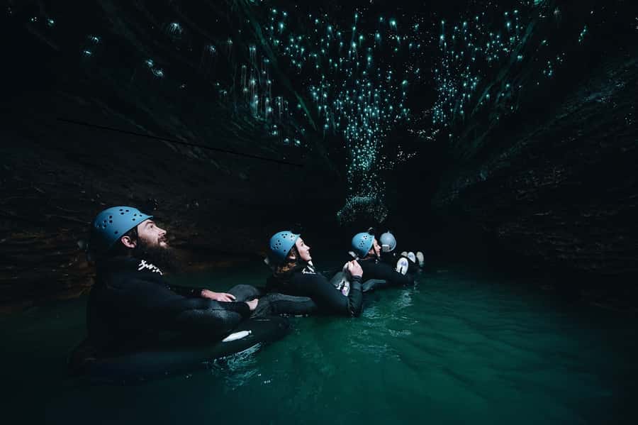 Waitomo Caves: Labyrinth Black Water Rafting Experience - Getting suited up for 10 to 14 degree water